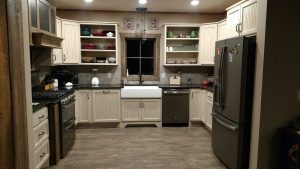 Rub through Paint with antiquing and Rustic Alder bead board cabinets combined with Stained hood with hammered wrought iron inserts.