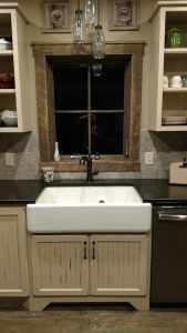 Rub through Paint with antiquing and Rustic Alder bead board cabinets and farmhouse sink.