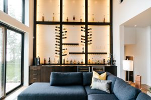 Modern Frameless Alder bar with unique custom wine bottle holder.