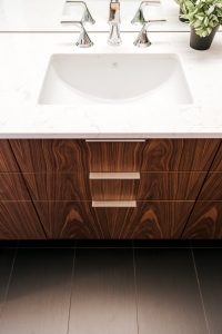 frameless vertical grain walnut vanity with undermount sink and quartz top