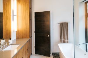 frameless vertical grain walnut vanity with undermount sink and quartz top