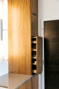 Tall frameless walnut bathroom storage