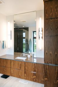 frameless vertical grain walnut vanity with undermount sink and quartz top