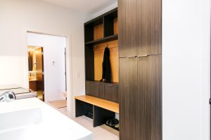 frameless Greigio Note laminate with Alder top and backboard bench and coat storage.