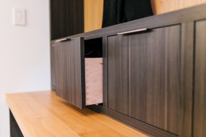 frameless Greigio Note laminate with Alder top and backboard bench and coat storage.