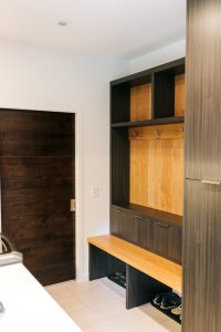 frameless Greigio Note laminate with Alder top and backboard bench and coat storage.