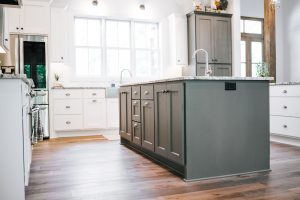 Kitchen Island and tall wall cabinet painted Grizzle Grey with white cabinets