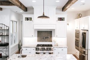 Wood hood painted with glass upper sides cabinets, pot filler faucet, shaker style cabinet doors