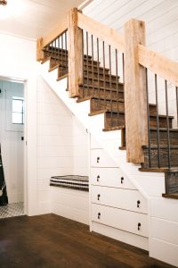 Built-in full overlay dresser under stairs painted Navajo White