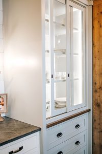 Sliding glass door hutch painted Oyster with inset doors below.