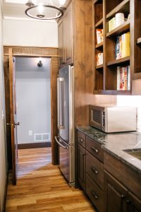 Rustic Alder pantry with open finished cabinet uppers, extra refrigerator and sink