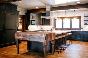 Rustic oak skip sawn island with butcher block, floating shelves and rustic Alder painted inset cabinet perimeter