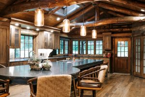 Distressed Rustic Hickory kitchen cabinets with shiplap panel inserts and wire mesh uppers and farm sink