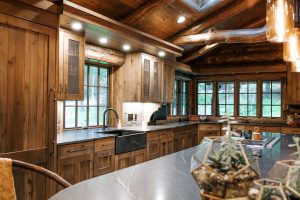 Distressed Rustic Hickory kitchen cabinets with shiplap panel inserts and wire mesh uppers and farm sink