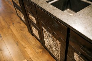 Close up of bark panel insets on cabinet doors