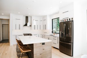 Two toned Kitchen with white perimeter cabinets, rustic soft maple book matched horizontal grain island
