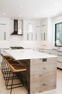 Two toned Kitchen with white perimeter cabinets, rustic soft maple book matched horizontal grain island