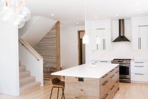 Two toned Kitchen with white perimeter cabinets, rustic soft maple book matched horizontal grain island