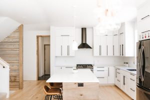 Two toned Kitchen with white perimeter cabinets, rustic soft maple book matched horizontal grain island